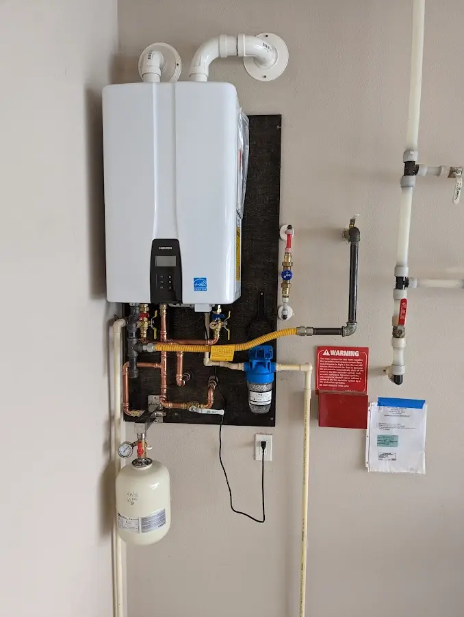 Professional plumber installing copper piping in a Beach Park home